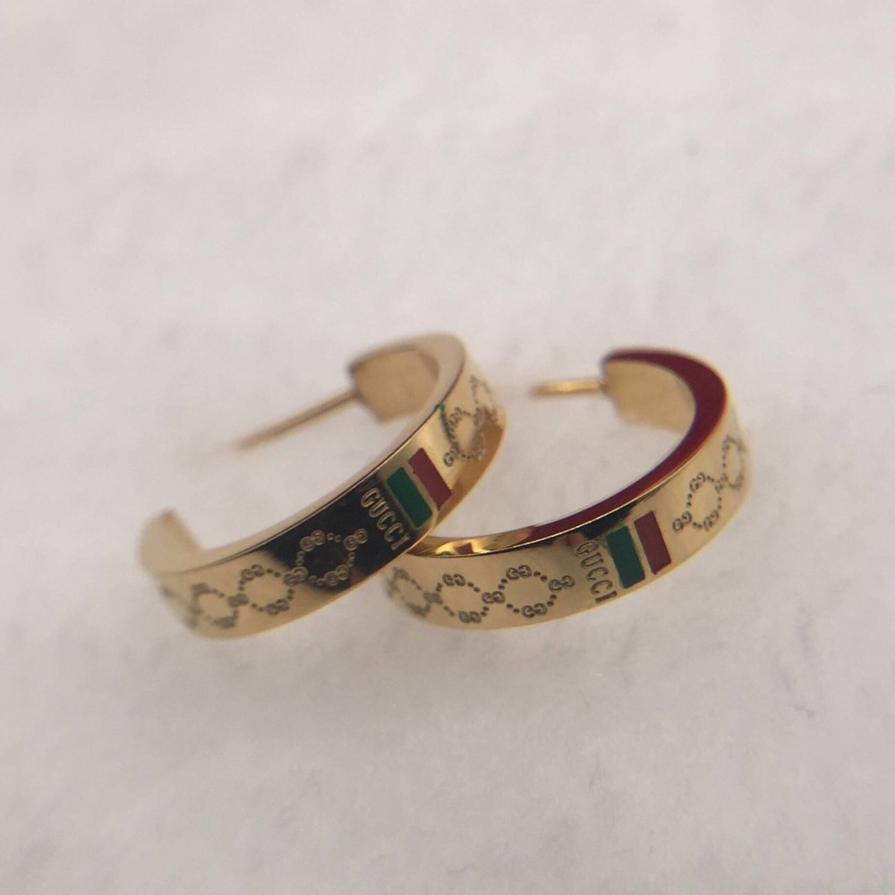 Gold G hoops earrings with red and green details